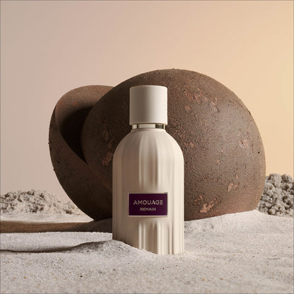 Amouage Remain Eau de Parfum bottle on a soft neutral background