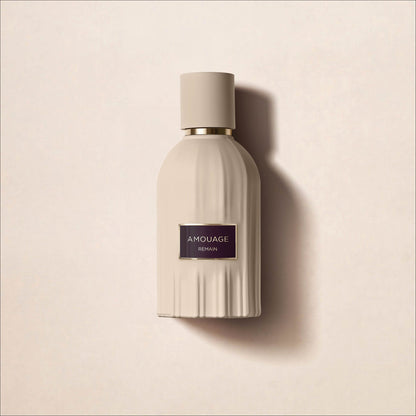 Amouage Remain Eau de Parfum bottle surrounded by sand and sculptural forms