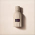 Amouage Remain Eau de Parfum bottle surrounded by sand and sculptural forms